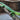 Green lizard on a wooden surface